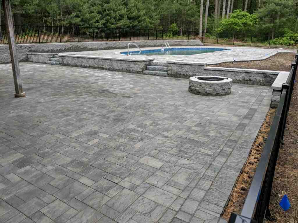Paver pool deck with fire pit under construction